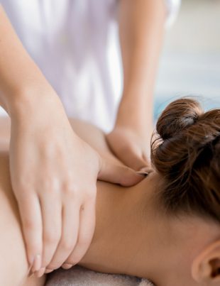 a woman giving her customer a back therapy massage