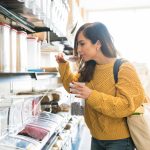 A female looking through groceries at the snack display rack