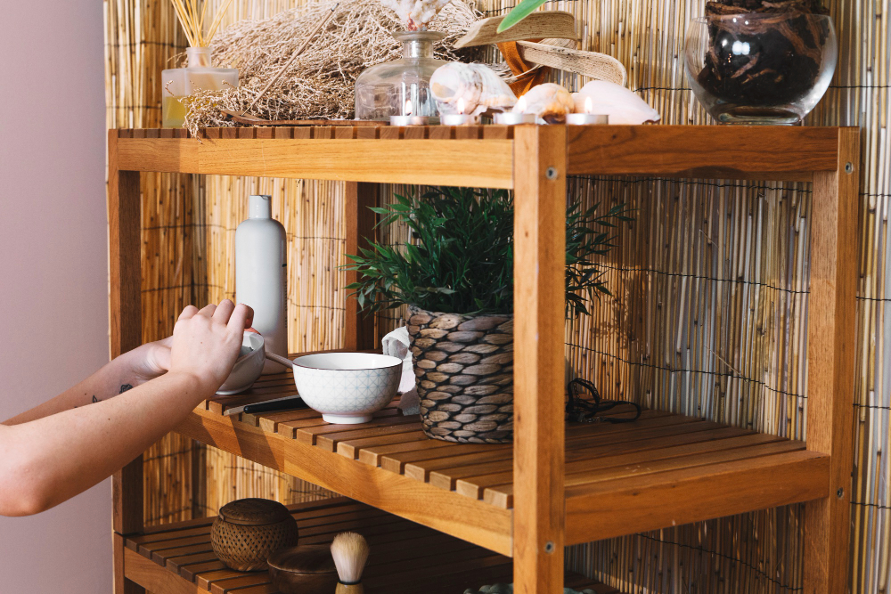 a woman rearranging things on her wooden display rack