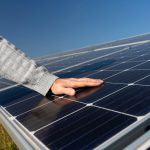 A technician making sure the solar panels are maintained