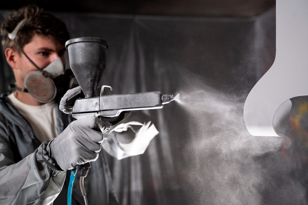 A guy using spray painting system