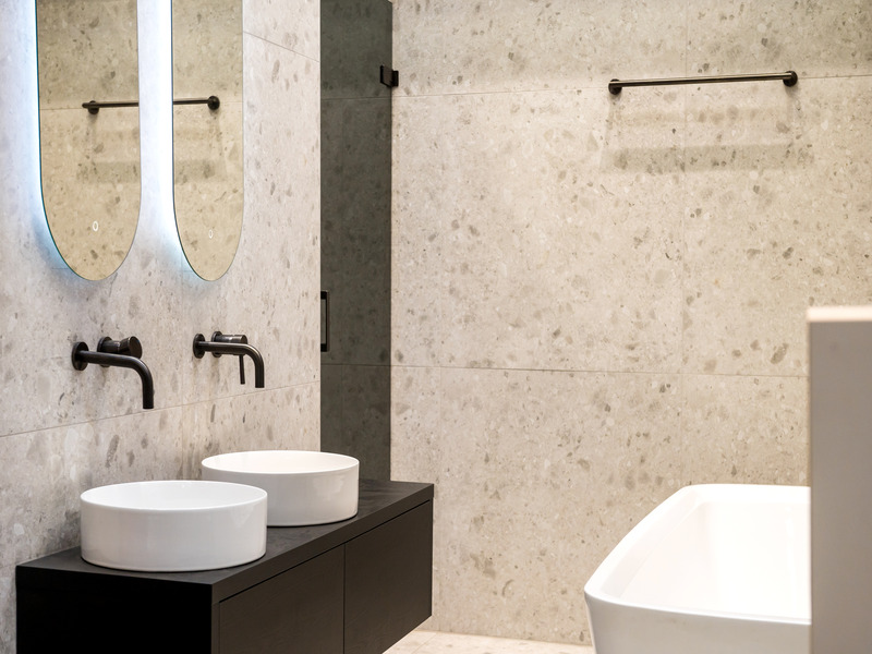 A modern bathroom featuring terrazzo floor and wall tiles designs.